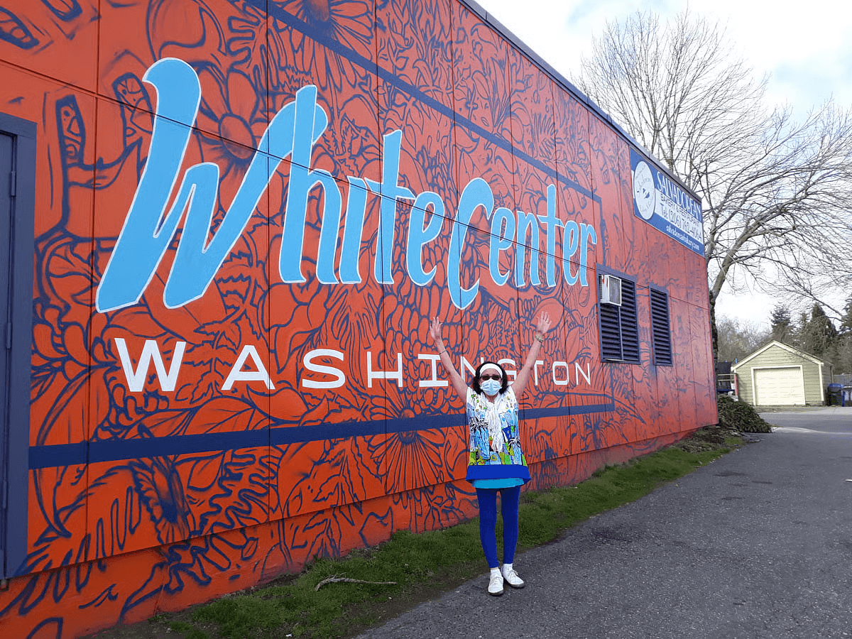 Aminta at the White Center in front of bakery
